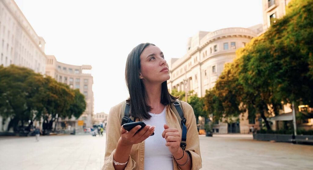 Woman walking through a new city sightseeing and thinking