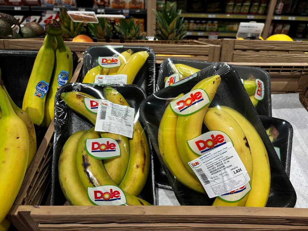 Bananas on Styrofoam Wrapped in Plastic in a Supermarket in Italy